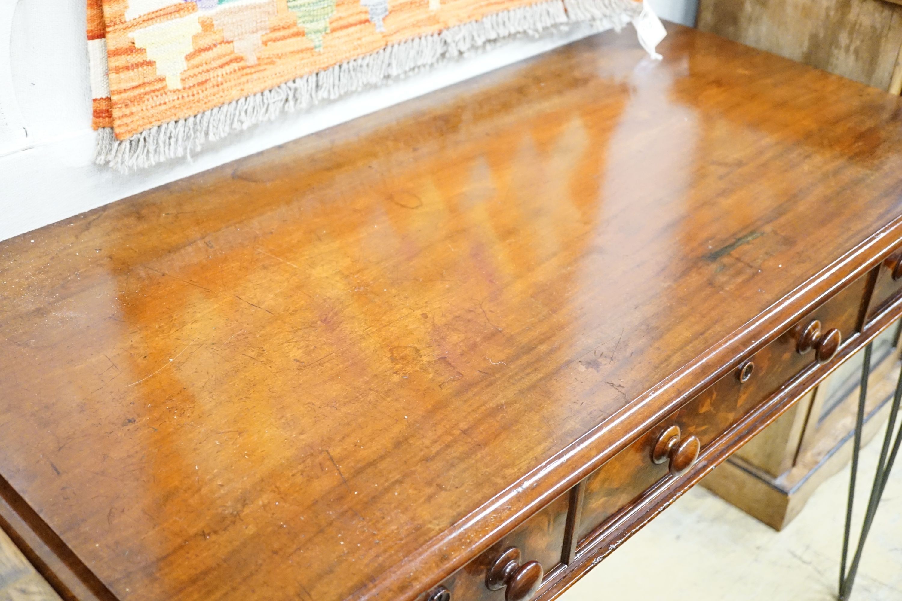 A Victorian mahogany writing table raised on later wrought iron legs, width 118cm, height 82cm